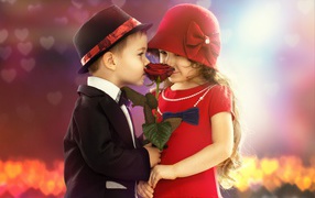 Little girl and a boy with a red rose