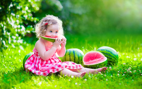 Little girl eating sweet watermelon 