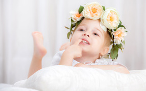 Little girl with a beautiful wreath of flowers on her head