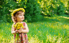 Little girl with a bouquet of dandelions
