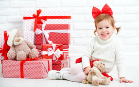 Little smiling girl with gifts for the new year