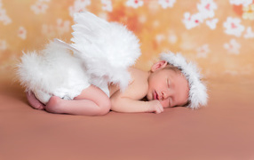 Lovely sleeping baby in an angel costume