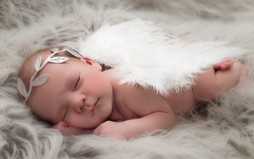 Спящий младенец с крыльями ангела