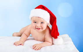 Smiling baby in a Christmas hat
