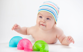 Smiling baby with toys rainbow