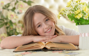 Smiling brown-haired girl with book