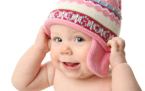 Smiling child in hat on white background