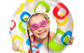 Smiling girl with an inflatable circle on a white background