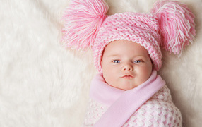 Sweet baby in a beautiful pink hat