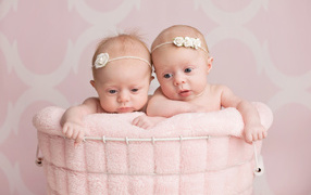 Два младенца близнеца девочки в корзине
