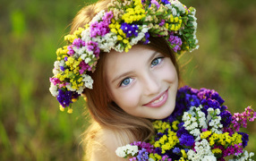 Little blue-eyed girl with wildflowers