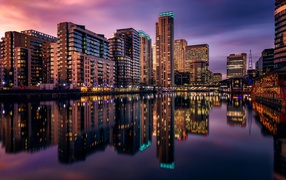 London's night skyscrapers are reflected in the water, Britain