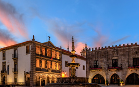 Houses and a fountain in the evening square in the town of Viana, Portugal