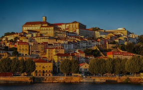 Panorama of the city of Coimbra near the water at sunset, Portugal