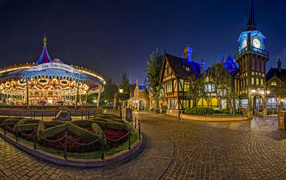 Карусели в гирляндах в парке Диснейленд, Калифорния. США