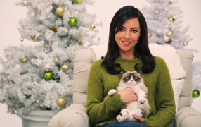 Actress Aubrey Plasa with a cat at a New Year tree