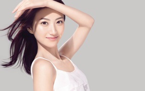 Actress Jing Tian in a white dress photo on a gray background