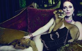 Actress Julianne Moore is lying on the couch with little lions