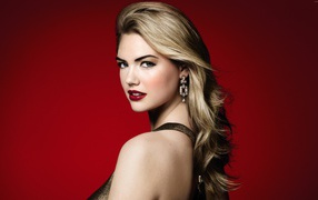 Beautiful American actress, model Kate Upton photo on a red background