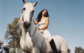 Young actress Catherine McPhee on a white horse