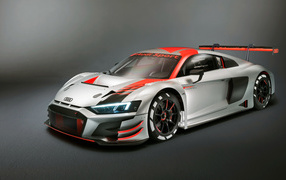 Спортивный автомобиль Audi R8 LMS 2019 года на сером фоне