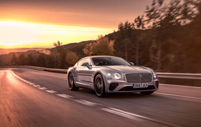 Silver car Bentley Continental GT 2018 on the background of sunset