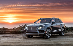 Black stylish stylish Bentley car on sunset background