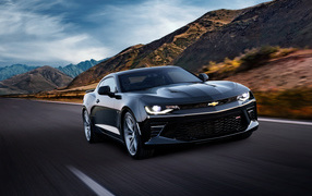 Black fast car Chevrolet Camaro SS, 2018 on the highway in the mountains