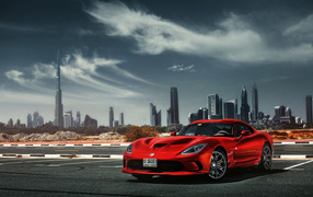 Red sports car Dodge Viper SRT 2018 on the background of the city