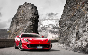 Red 2018 Ferrari Portofino sports car on the background of mountains