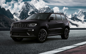 Black Jeep Grand Cherokee S, 2019 against the background of snow-capped mountains