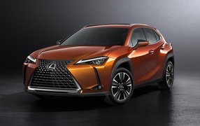 Оранжевый автомобиль Lexus UX, 2019 на сером фоне