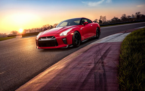 Red car 2018 Nissan GT-R on the track at sunset