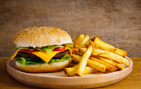 Appetizing hamburger on a table with french fries