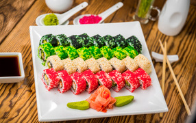 Аппетитные роллы с имбирем и соусом васаби на белой тарелке 