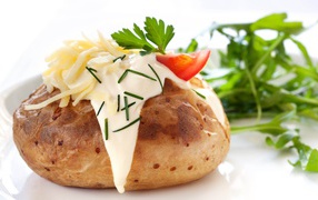 Baked potatoes with sour cream, cheese and greens