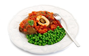 Green peas on a white plate with meat