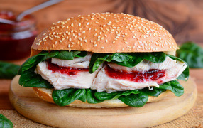 Hamburger with chicken and green spinach leaves
