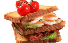 Сэндвич с яйцами, беконом и помидорами на белом фоне