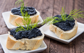Sandwiches with black caviar and dill