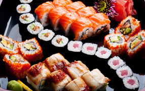 Tasty rolls and sushi on a plate