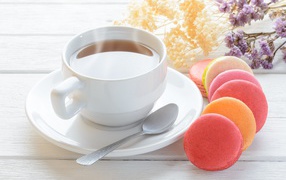 White cup of tea with macaroons