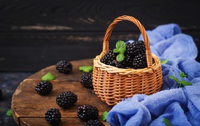 Basket of ripe juicy blackberries on the table