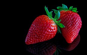 Beautiful large red strawberry on a black background