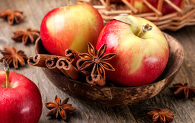 Красивые красные яблоки на столе с бадьяном и корицей