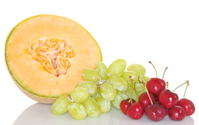 Melon, grapes and cherries on a white background