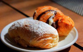 Свежие аппетитные булочки на белой тарелке