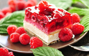 A piece of cheesecake with raspberry berries