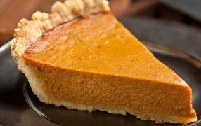 A piece of delicious pumpkin pie on the table