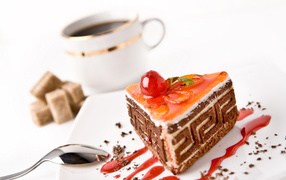 Appetizing cake on the table with a cup of coffee and sugar